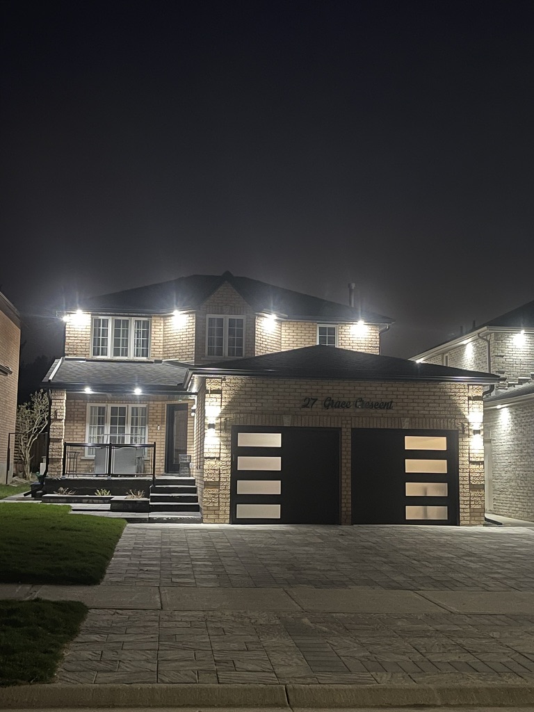 Luxury home exterior with professional lighting at night