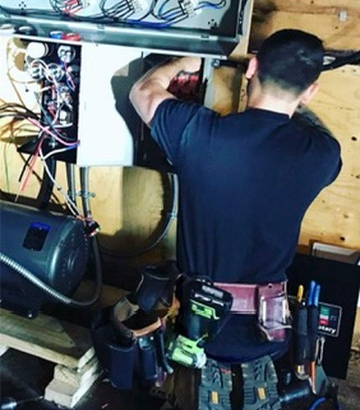 Electrician working on electrical panel